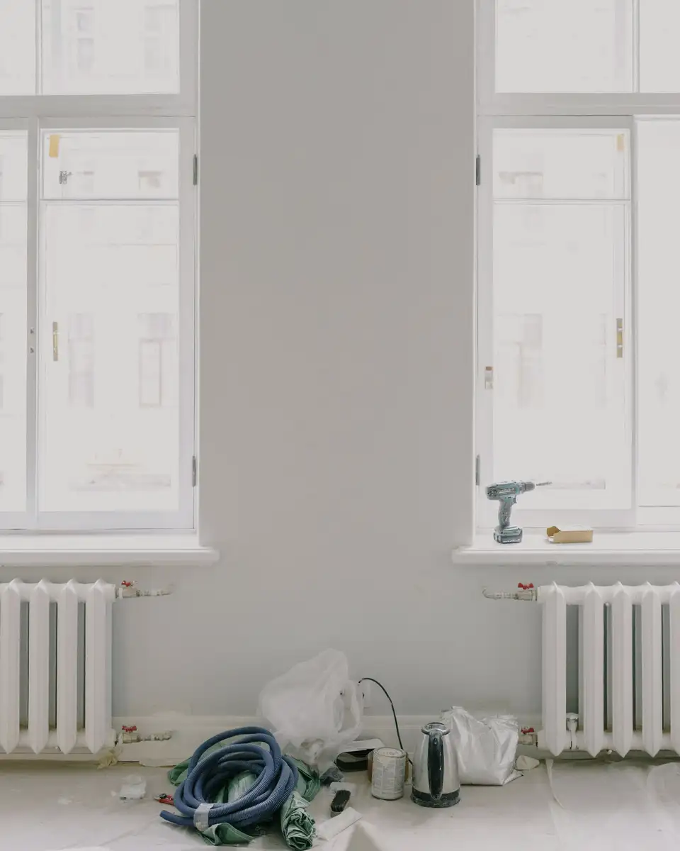 New wooden windows above radiators in a bright, finished room