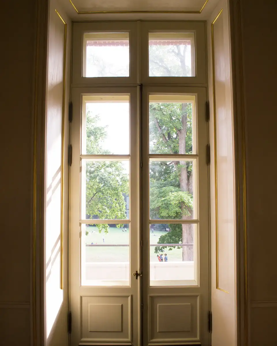 A glass door looking onto a green garden