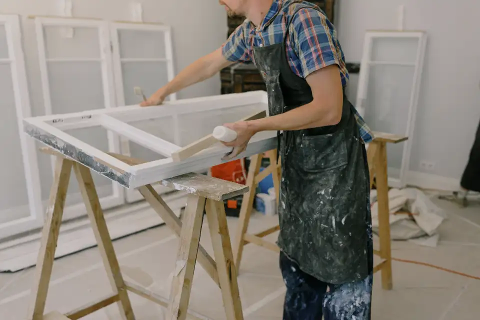 Window frames on a wooden workbench in a bright workshop
